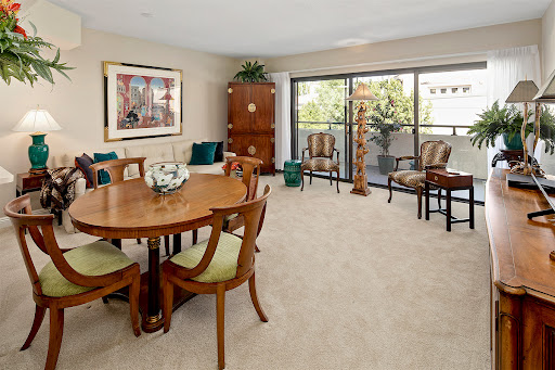 A cozy living and dining area showcasing elegant furniture and warm decor.