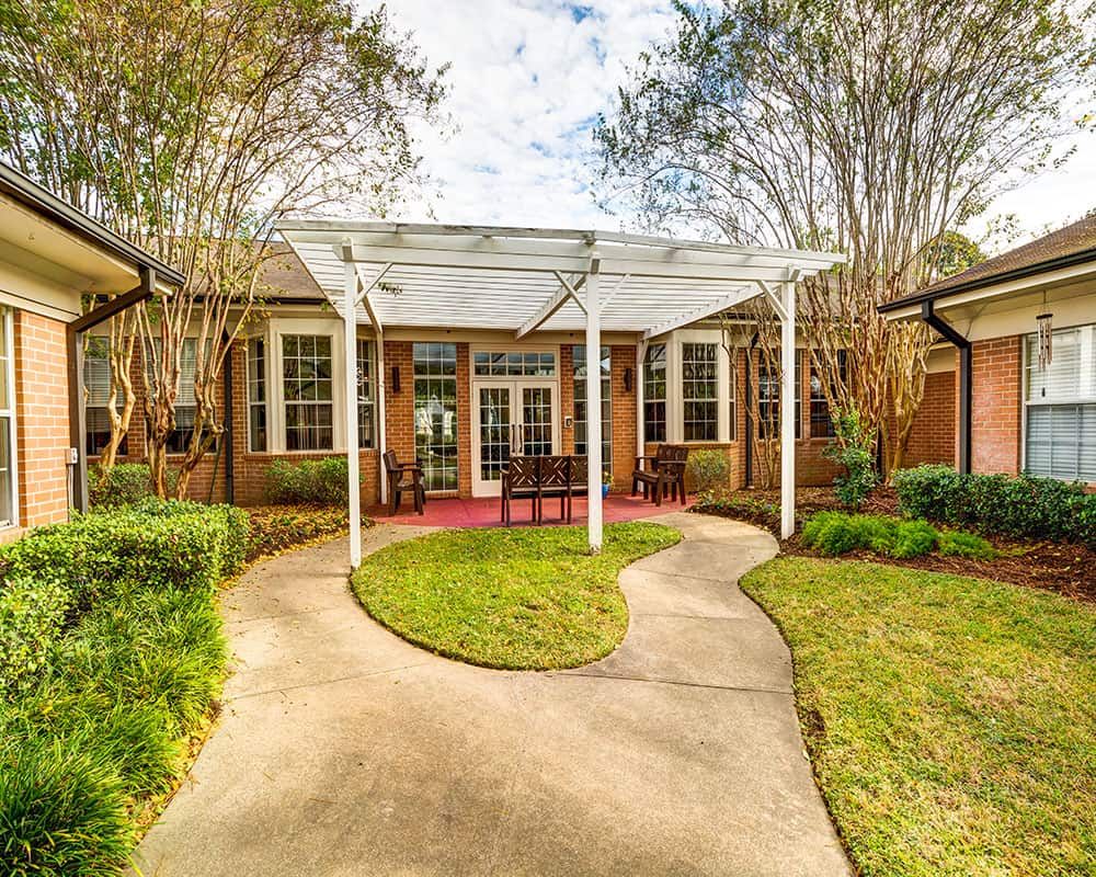 A charming house with a landscaped garden and inviting patio area.