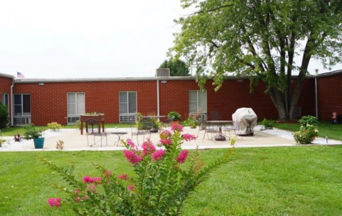 A cozy house with a well-maintained garden and patio area.