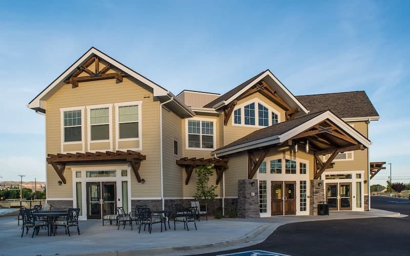 A modern residential building with large windows and a welcoming entrance.