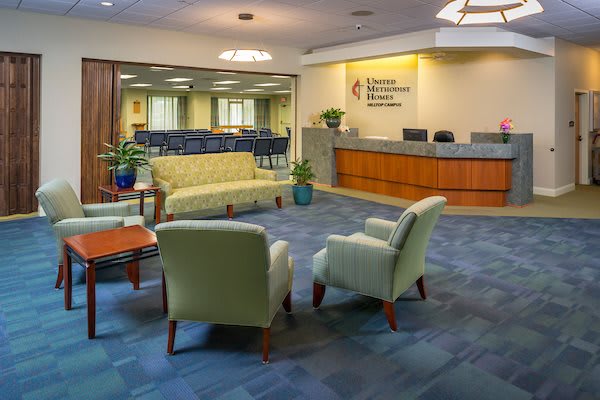 A spacious and comfortable waiting area with seating arrangements and a reception desk.