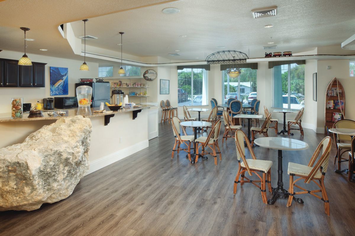 A cozy cafe with neatly arranged tables and chairs, offering a relaxed dining atmosphere.