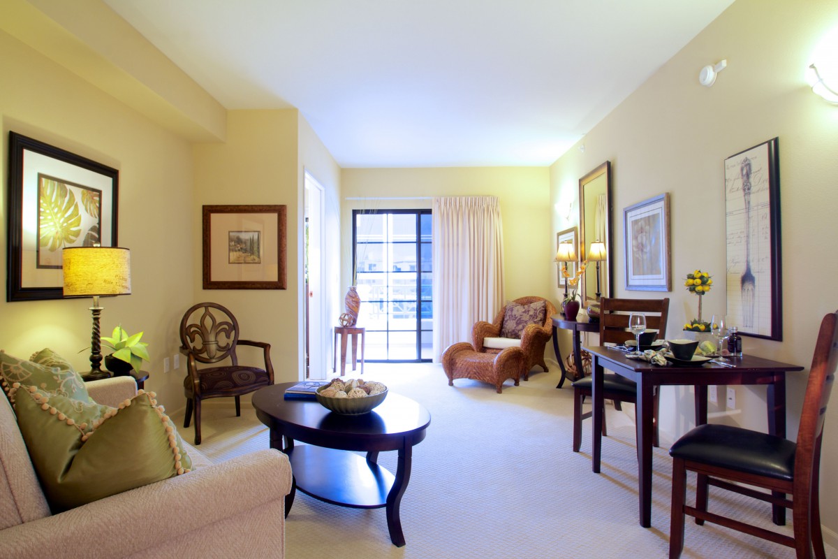 A cozy and well-decorated living room with elegant furniture and ample natural light.