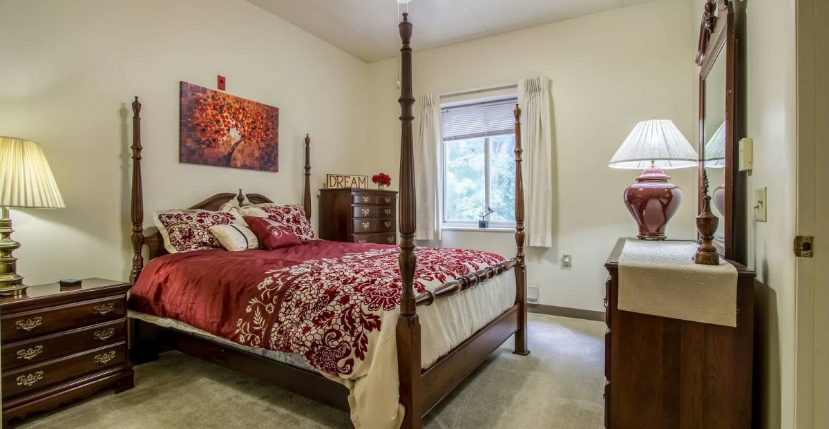 A cozy bedroom with a four-poster bed and elegant decor.