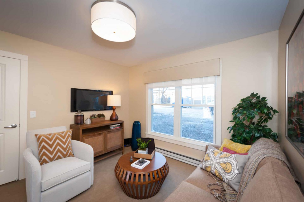 A cozy living room with a modern coffee table, comfortable seating, and stylish decor.