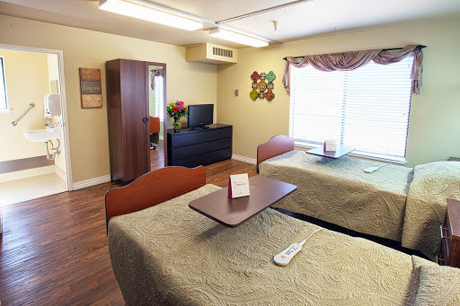 A comfortable and well-lit hospital room with two beds, designed for patient comfort.