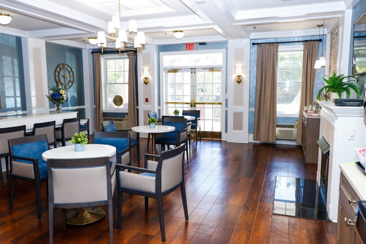 A stylish and cozy dining area with elegant furniture and wooden flooring.