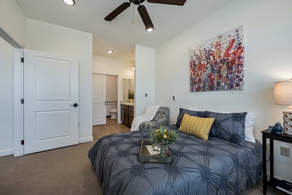 A modern bedroom featuring stylish decor and artwork.