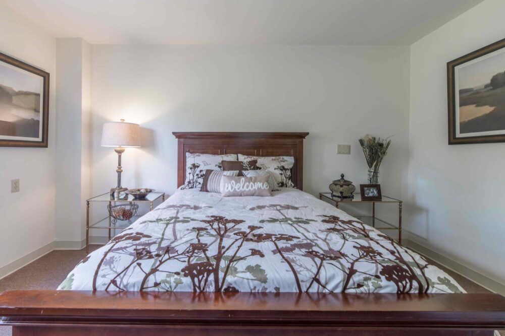 A cozy bedroom with a floral bedspread and matching decor.