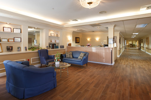 A welcoming lobby space with blue seating and a reception area.