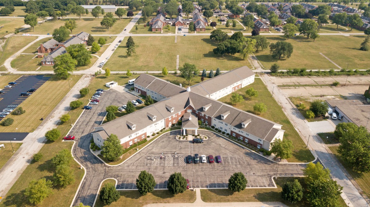 Aerial view of a suburban building with surrounding roads and parking areas.