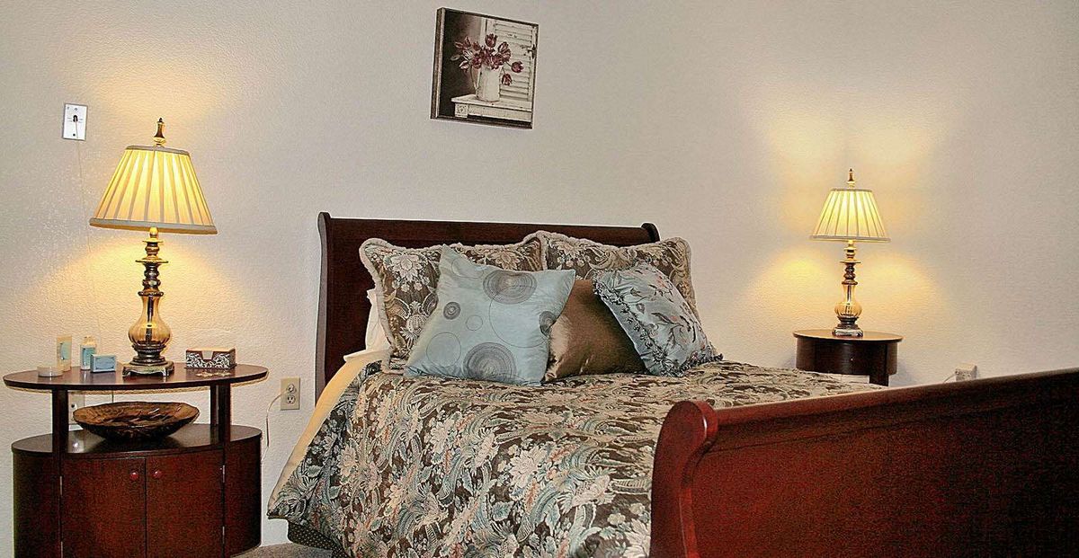 A cozy bedroom with decorative pillows and elegant bedding.