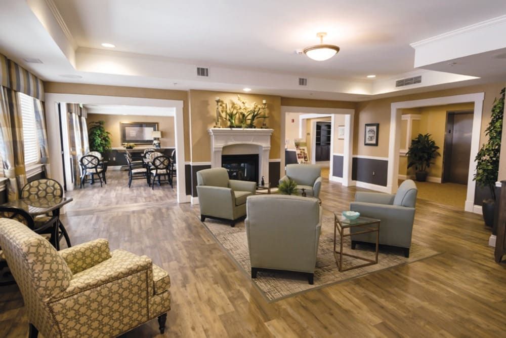 A cozy living room with comfortable seating, a fireplace, and elegant decor.