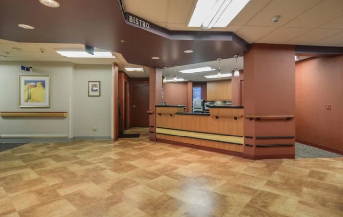 A modern reception area with a desk and warm lighting.