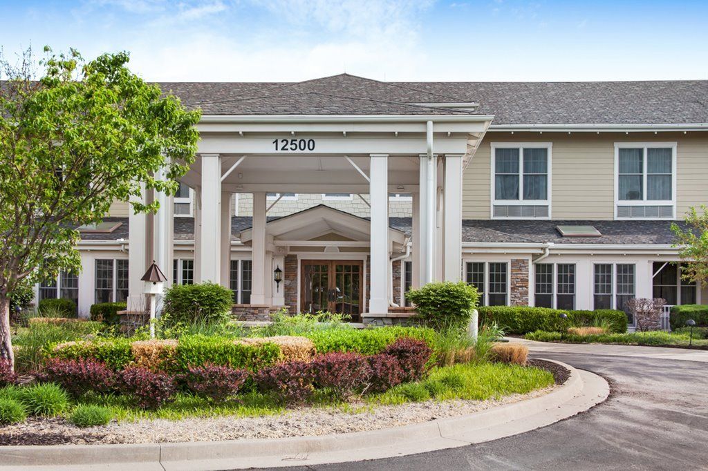 Entrance of a residential building with well-maintained landscaping.