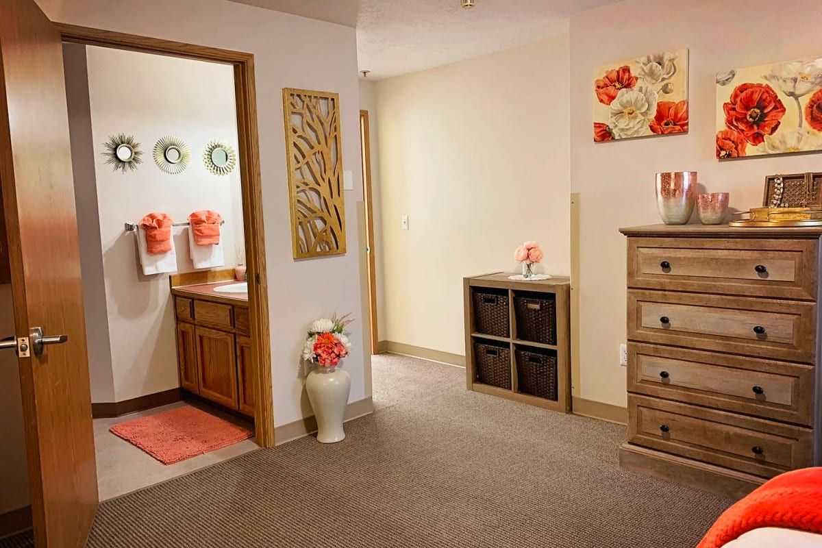 A cozy hallway with decorative elements and a view into a bathroom.