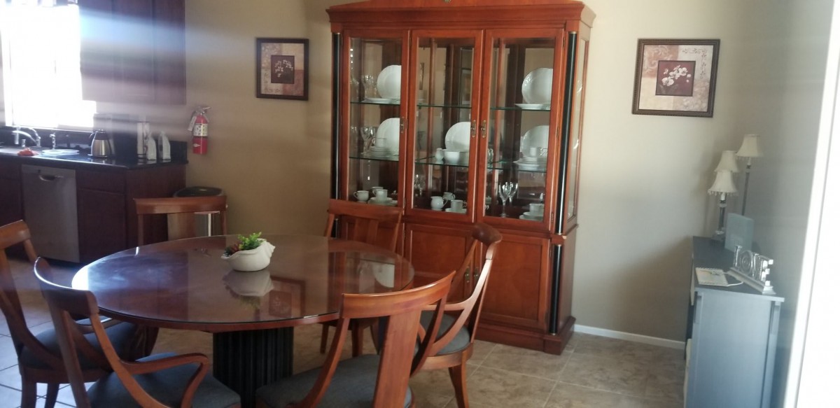 Elegant dining room with a wooden china cabinet and table set.