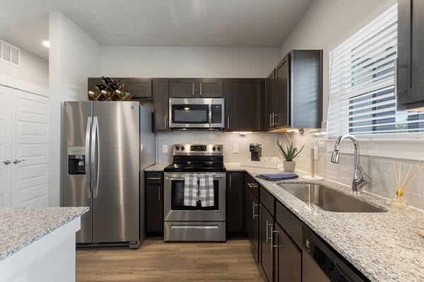 A modern kitchen featuring stainless steel appliances and granite countertops.
