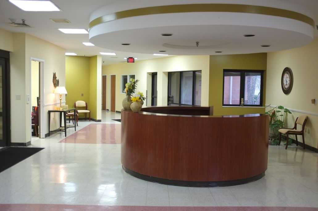 A spacious and modern reception area with a curved desk.