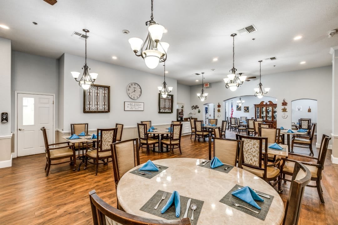 A well-lit dining area with neatly arranged tables and chairs, ready for guests.
