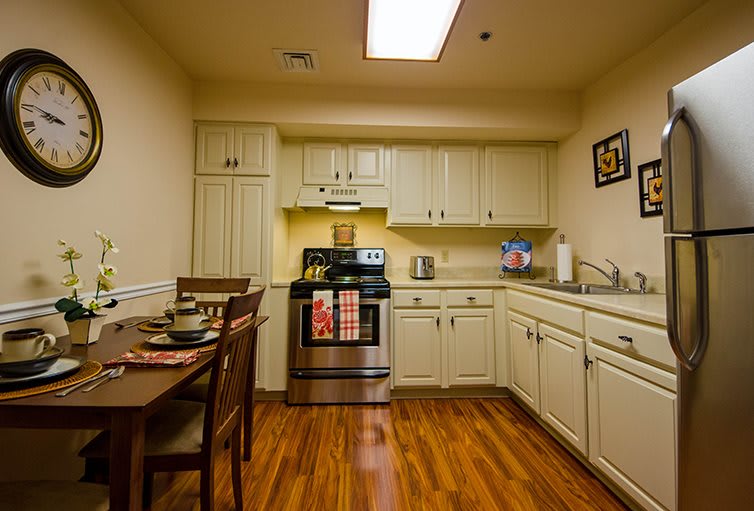 A cozy kitchen and dining area with modern appliances and wood flooring.
