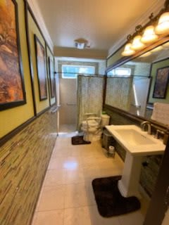 A well-decorated bathroom with modern amenities, including a sink, toilet, and shower.
