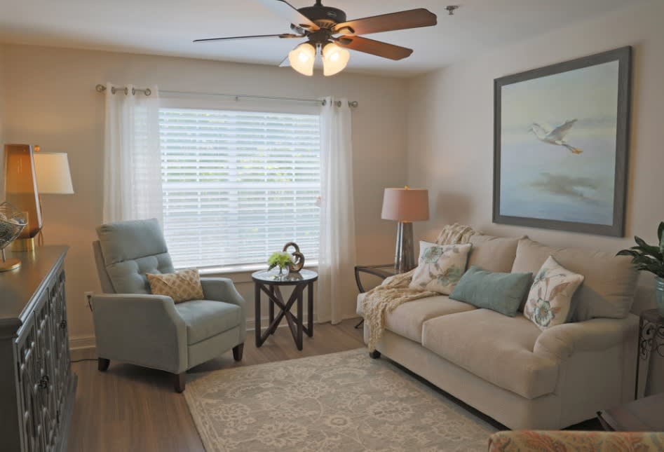 A cozy living room with a sofa, armchair, and decor elements creating a welcoming atmosphere.