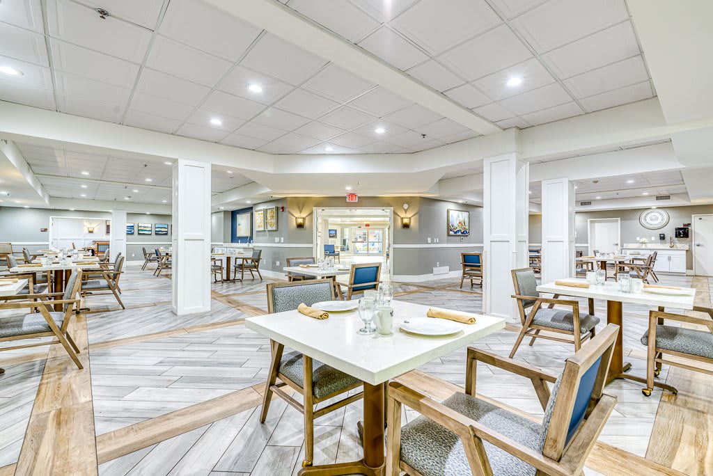 A modern and empty restaurant dining area with neatly arranged tables and chairs.