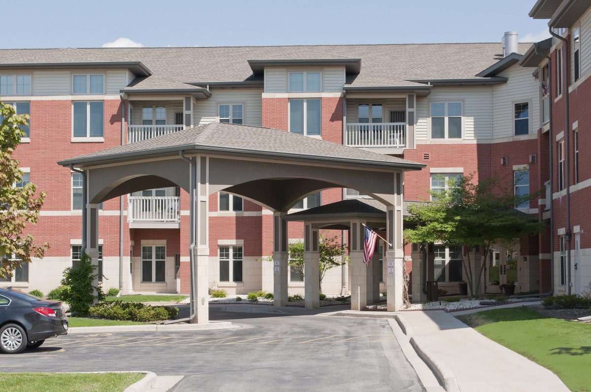 A residential apartment building with a covered entrance.