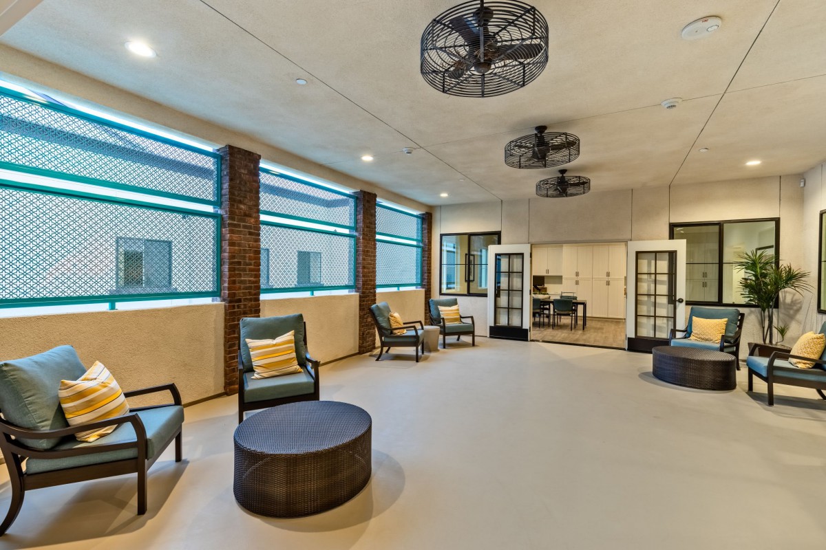 A modern indoor seating area with comfortable chairs and large windows.