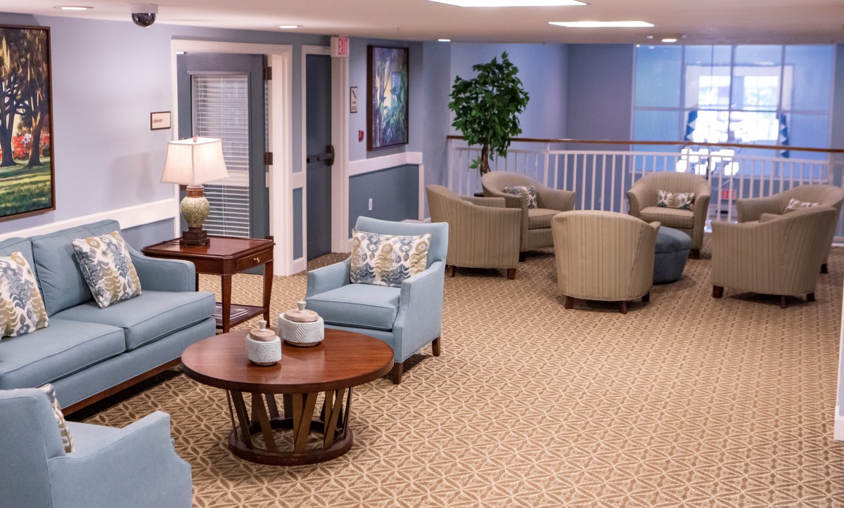 A cozy seating area with armchairs and a coffee table, featuring soft lighting and decorative elements.