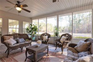 A cozy sunroom with wicker furniture and abundant natural light.