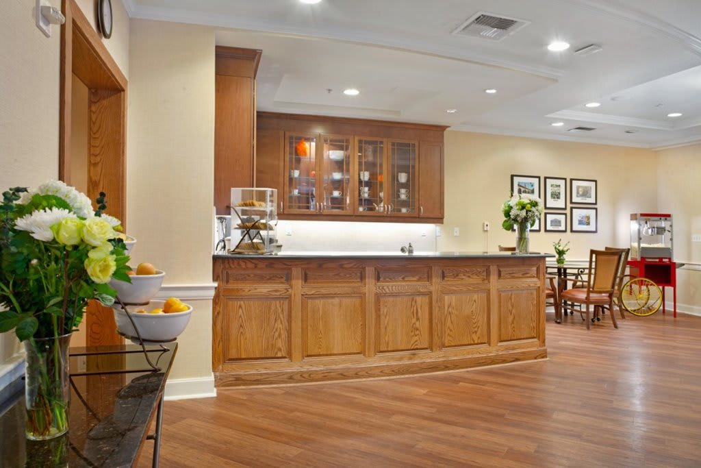 A cozy kitchen area featuring wooden cabinets, a countertop, and modern lighting.