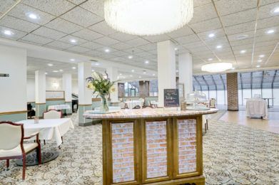 A modern restaurant interior with elegantly set tables and ambient lighting.