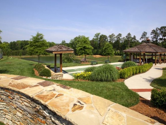 A beautifully landscaped garden with lush greenery, trees, and well-maintained pathways.