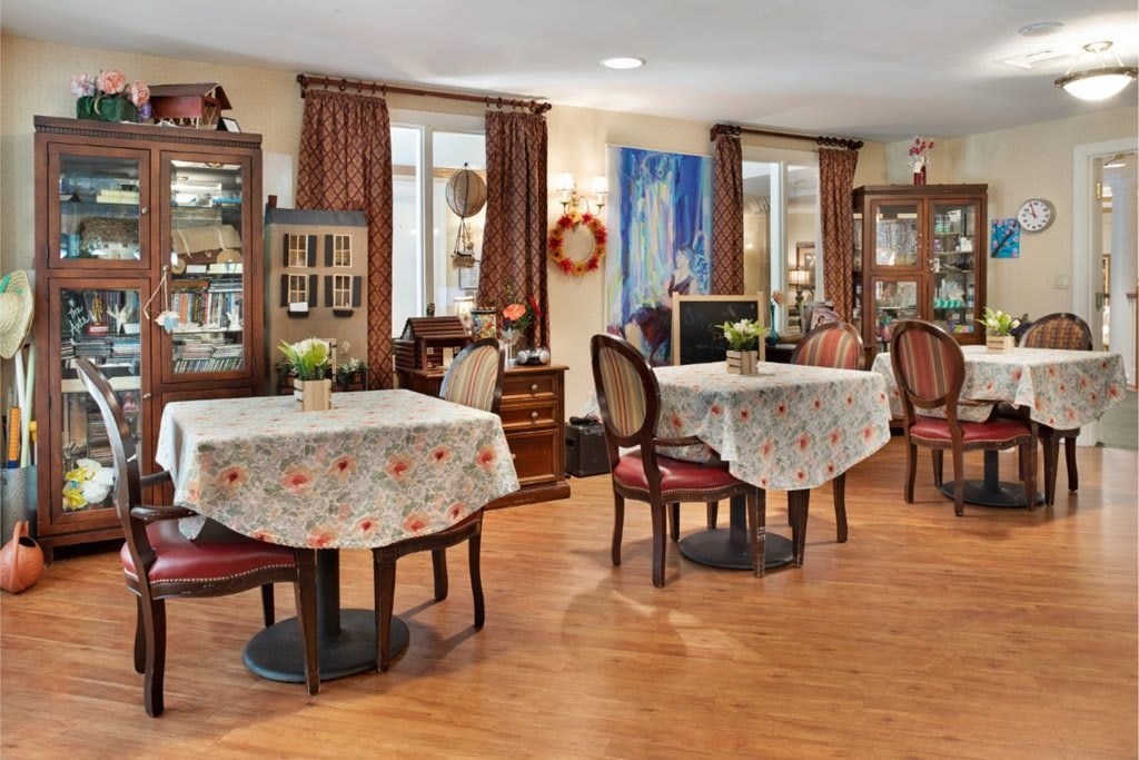 A cozy dining area with classic decor and warmly lit tables.