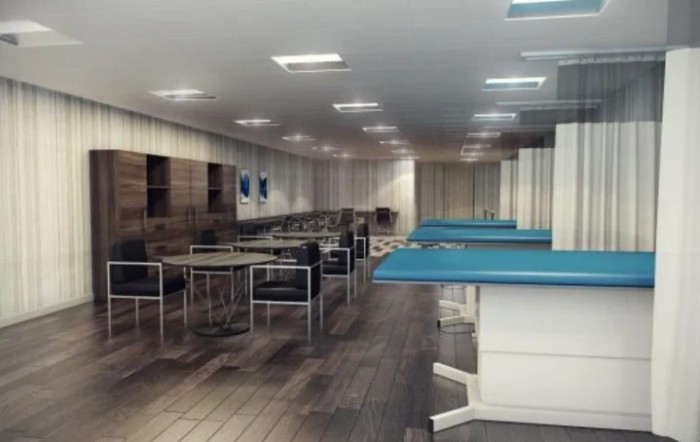 Interior view of a medical facility with multiple treatment beds and chairs.
