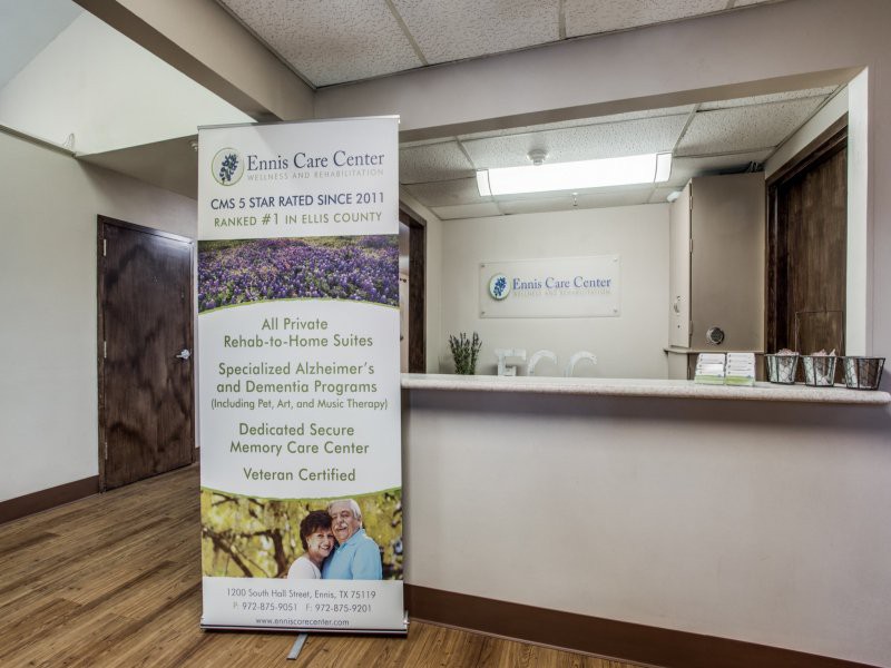 A clinic reception area featuring a promotional banner for holistic life care services.