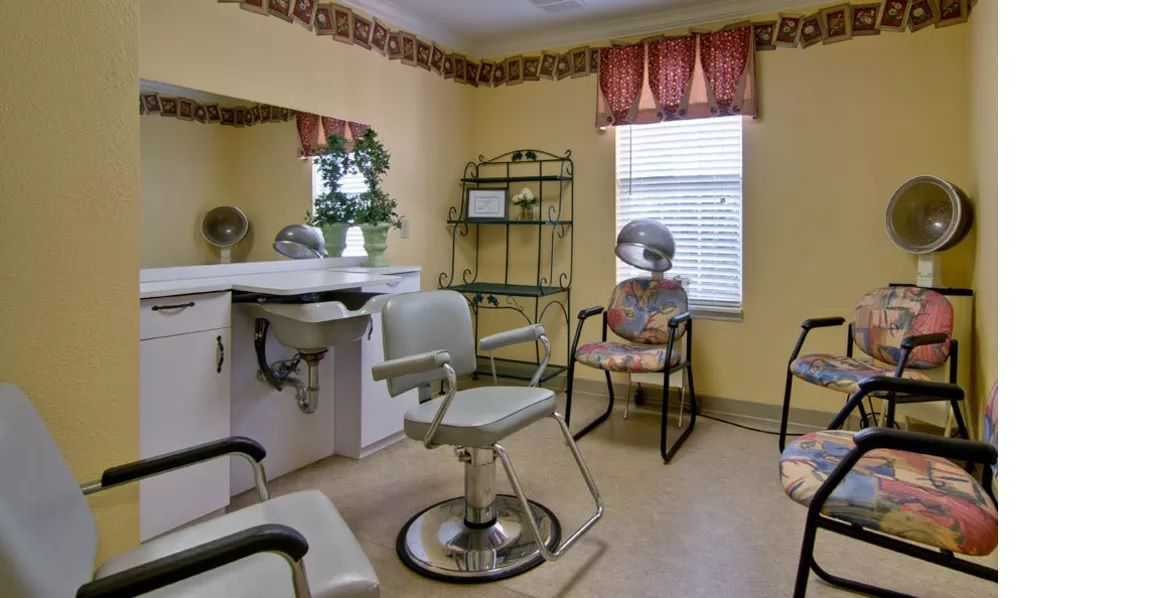 Interior of a hair salon with chairs and a hair dryer.
