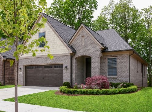 A charming suburban home with a brick exterior and well-maintained landscaping.