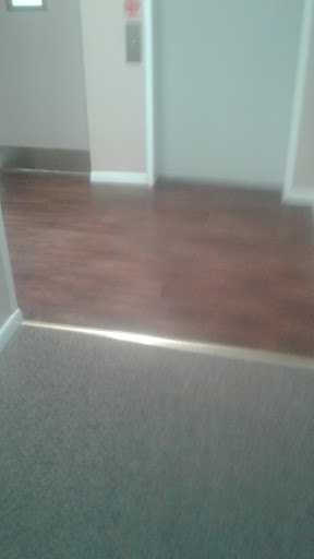 Transition between carpet and wooden flooring in an interior space.