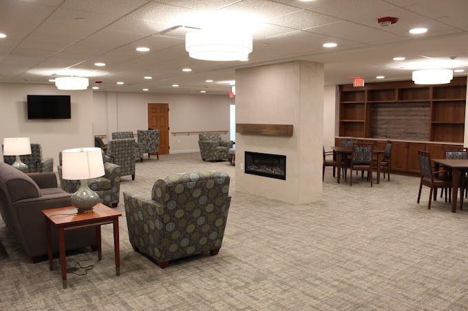 A spacious lobby with comfortable seating and a modern fireplace.