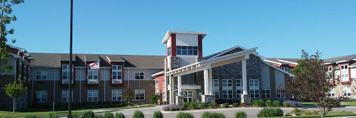 A modern community building featuring a blend of stone and colorful exterior elements, designed for welcoming residents.