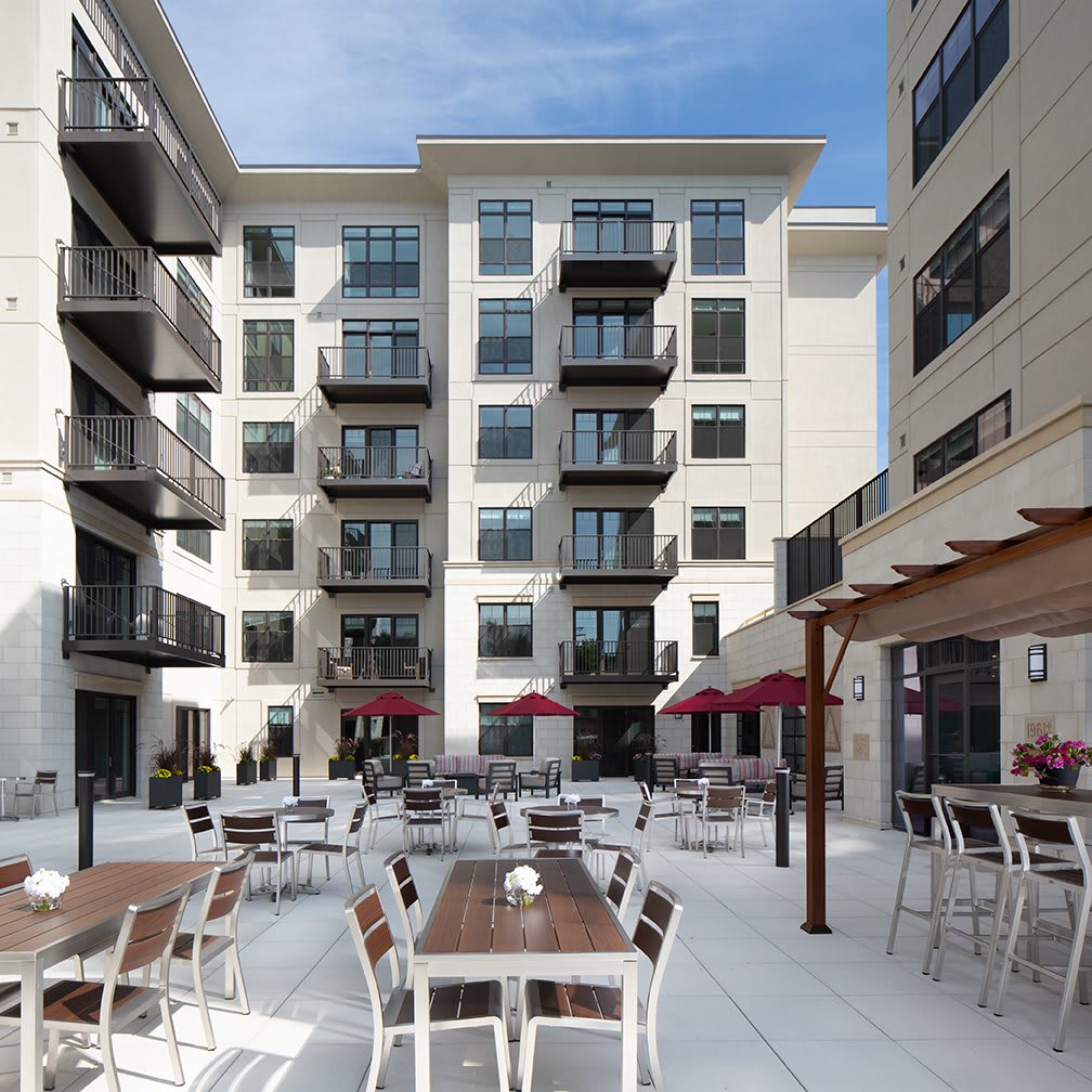 Modern apartment complex with an outdoor seating area in the courtyard.