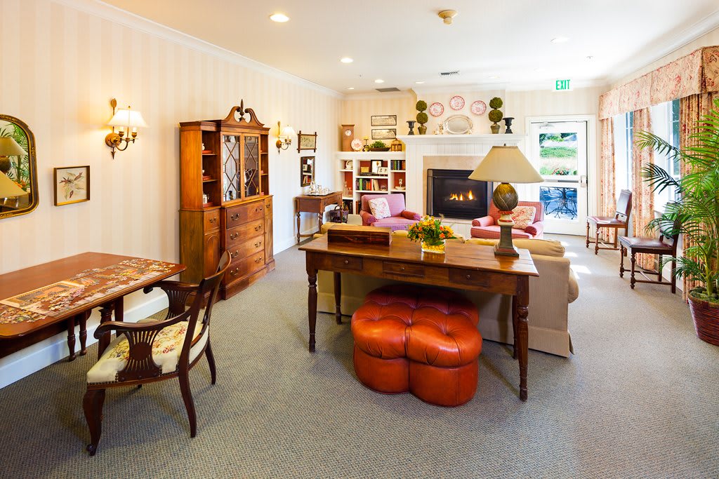 A cozy living room with traditional furniture and a warm fireplace.