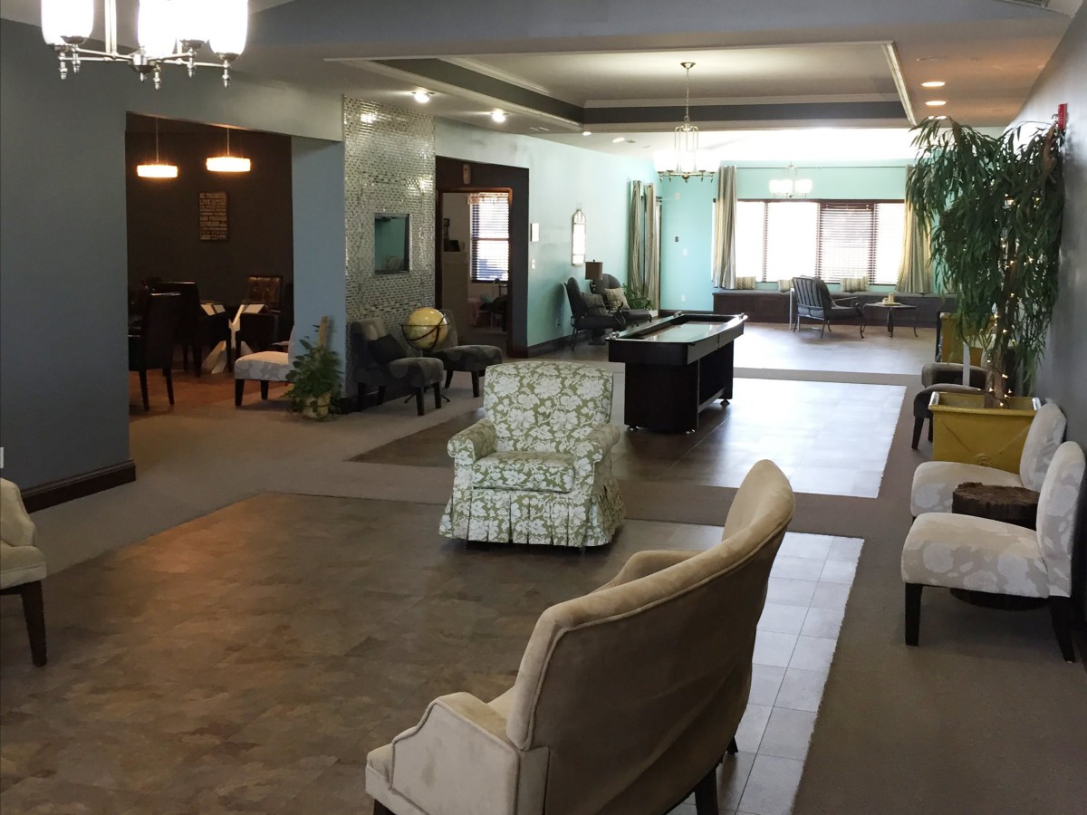 A spacious and modern lounge area with various seating options and a pool table.