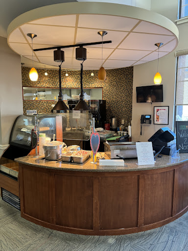 A cozy and modern coffee shop interior featuring a barista counter.