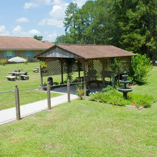 A peaceful outdoor pavilion set in a grassy area, perfect for picnics and gatherings.
