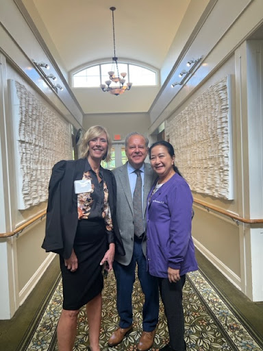 A group photo taken at an event in a beautifully styled hallway.
