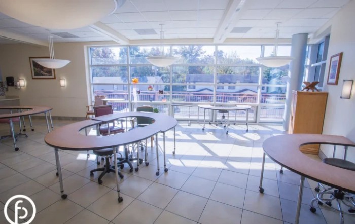 A modern classroom with large windows and stylish furniture.